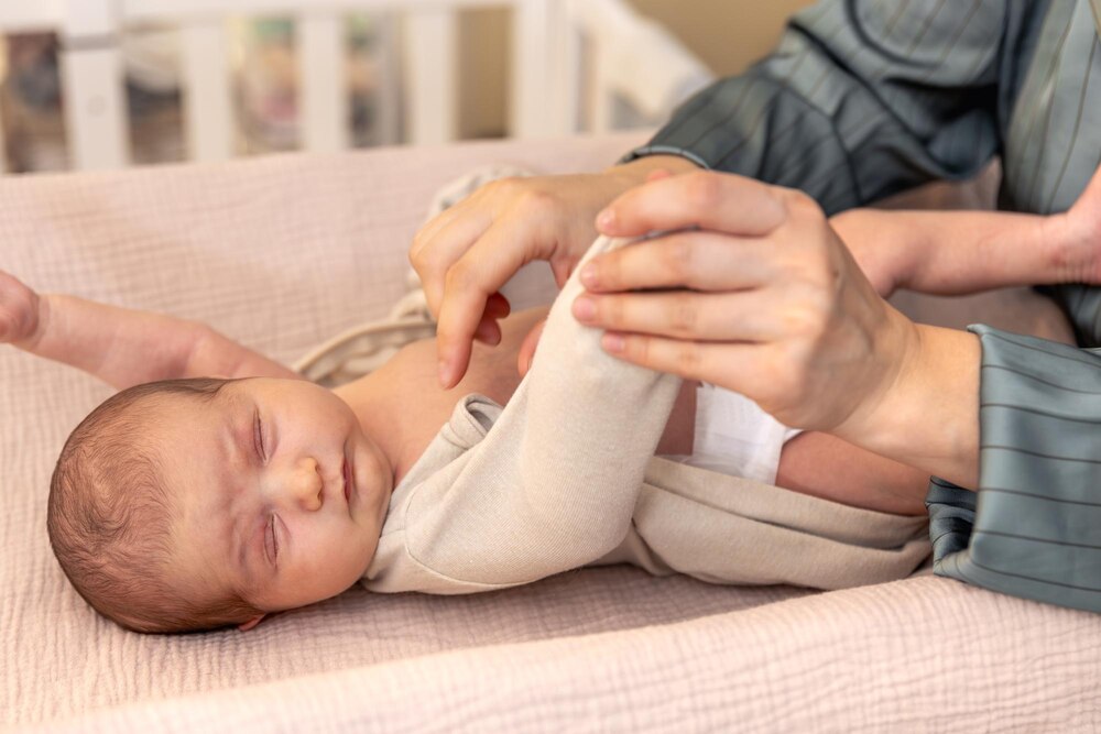 Mother wearing clothes to her baby baby healthcare hygiene concept